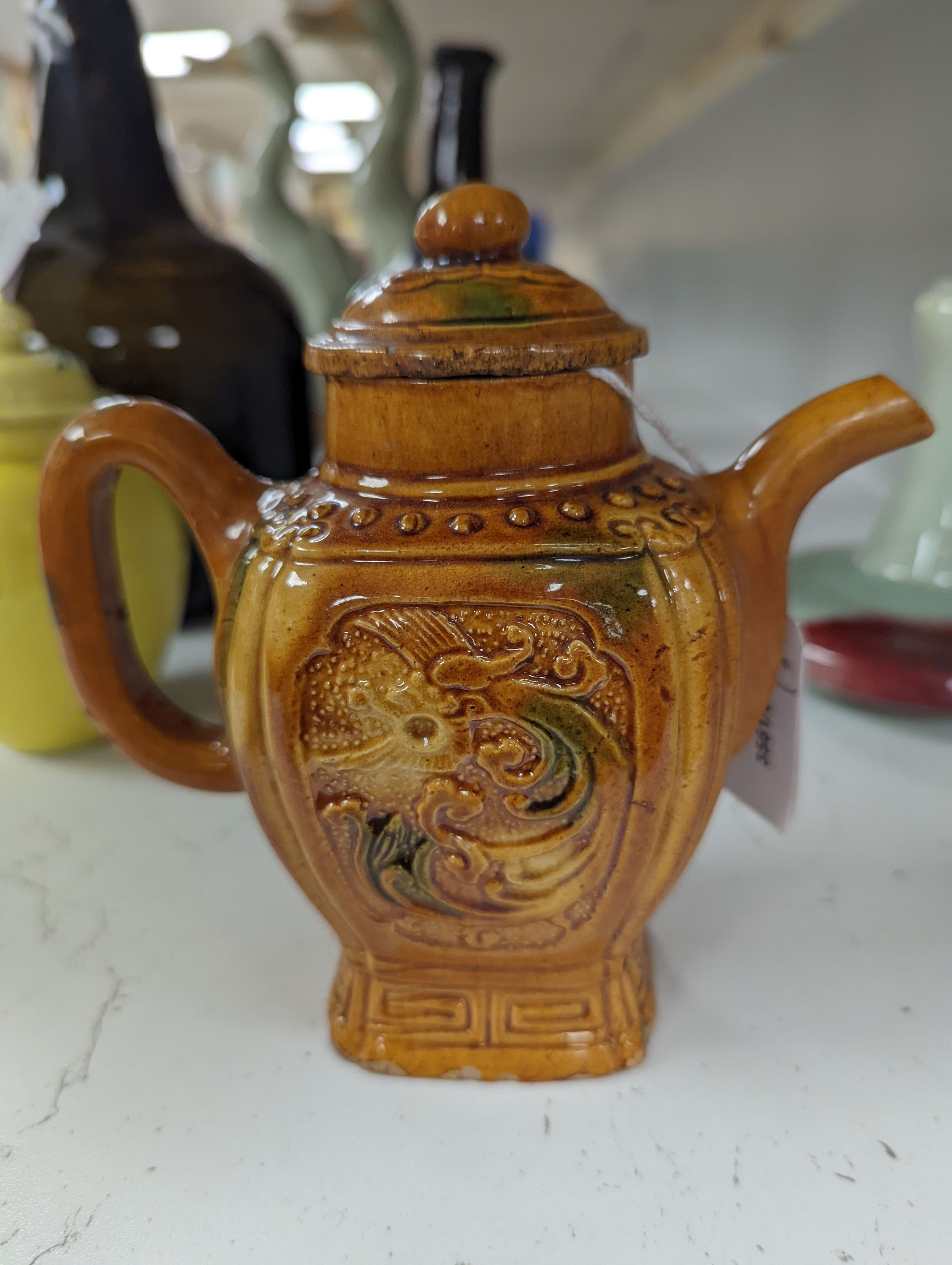 A Chinese enamelled yellow-ground jar and cover, a pottery teapot and cover and a flambe vase, latter 13cm